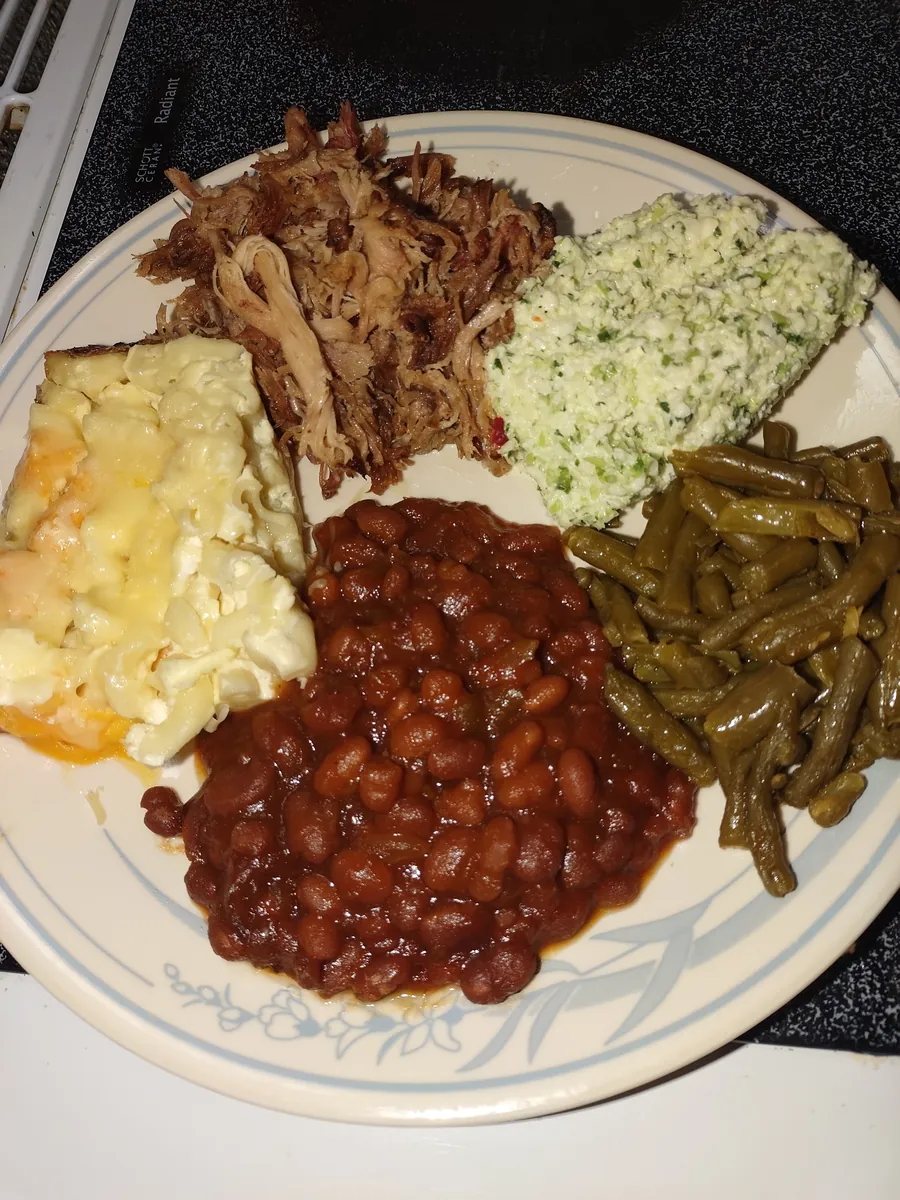 Pulled-pork BBQ plate with mac and cheese, slaw, baked beans, and green beans