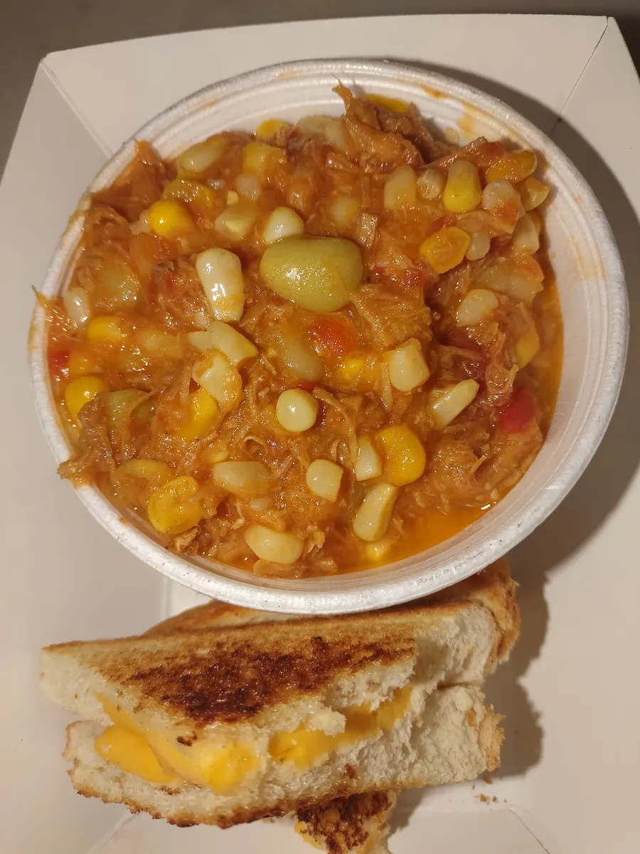 Bowl of Brunswick stew with a grilled cheese sandwich