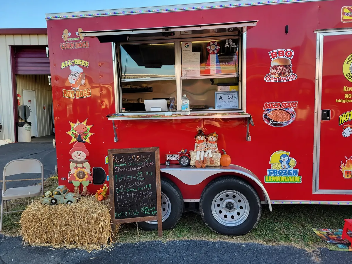 The red trailer decorated with hay bales and pumpkins at a fall festival