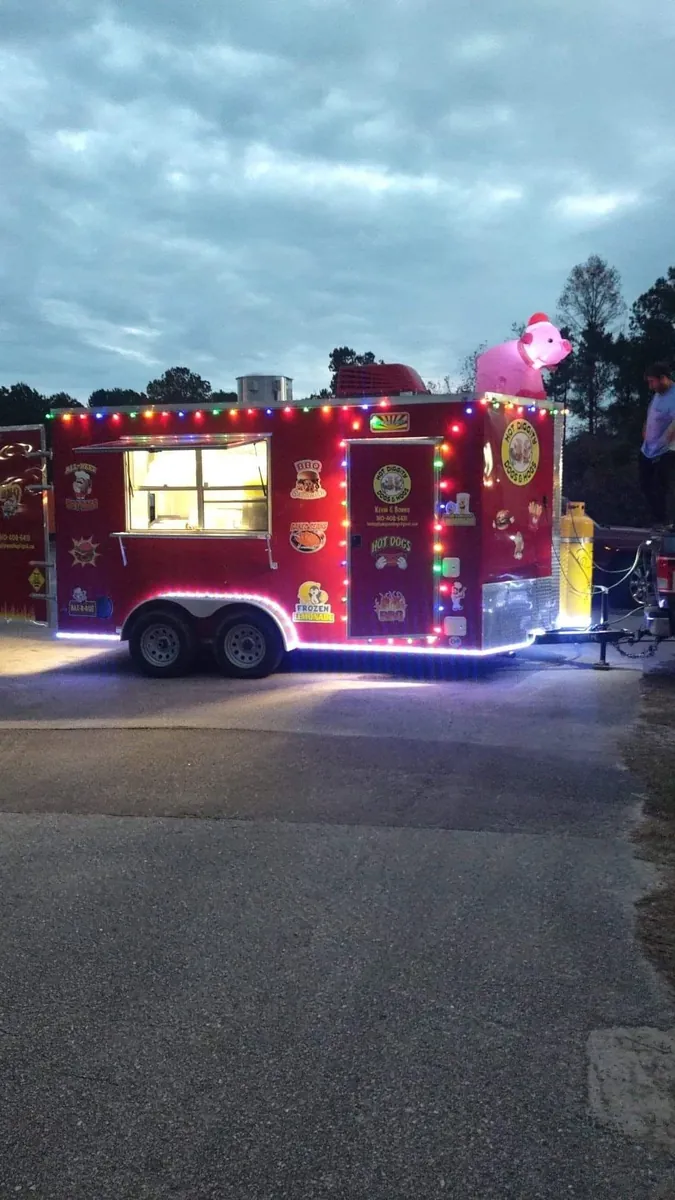 The trailer glowing with string lights at a night event