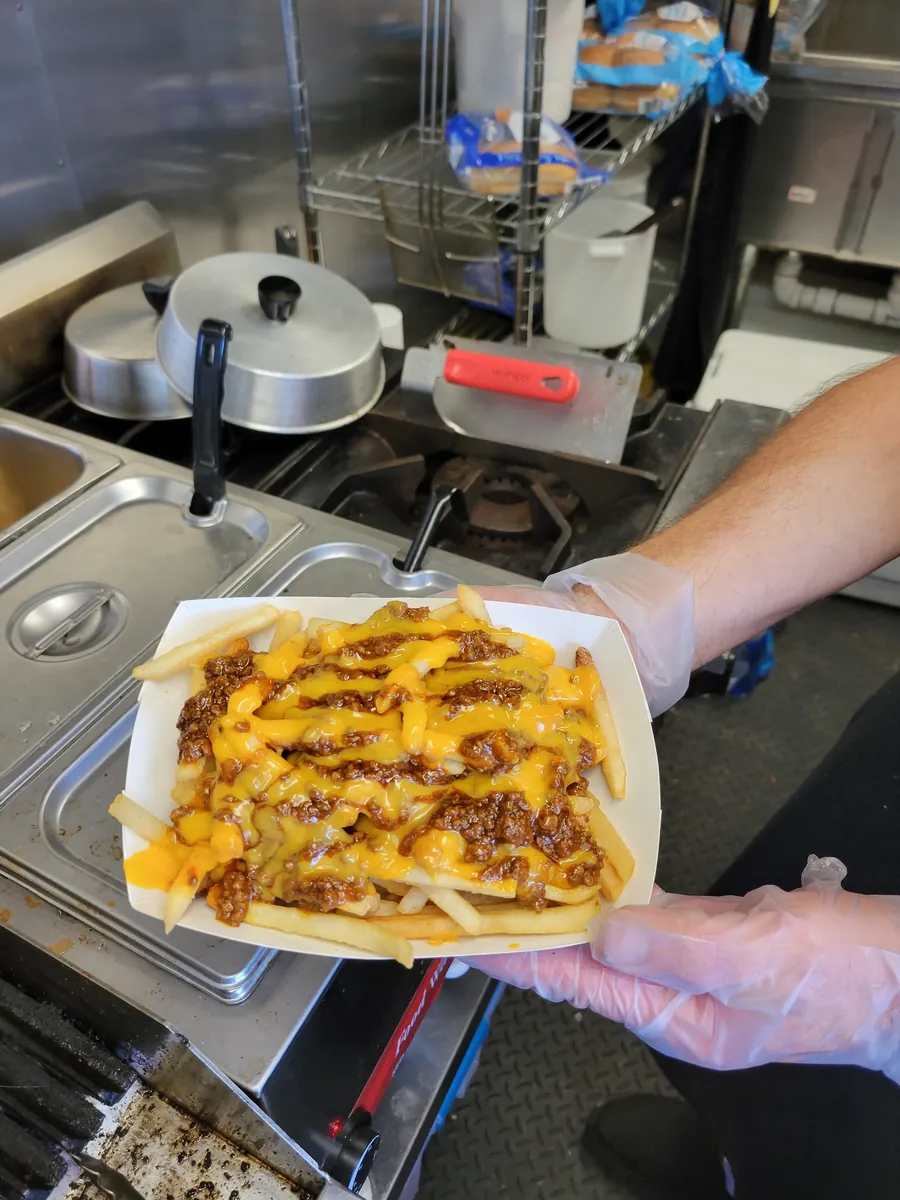 A loaded tray being handed fresh from the trailer kitchen